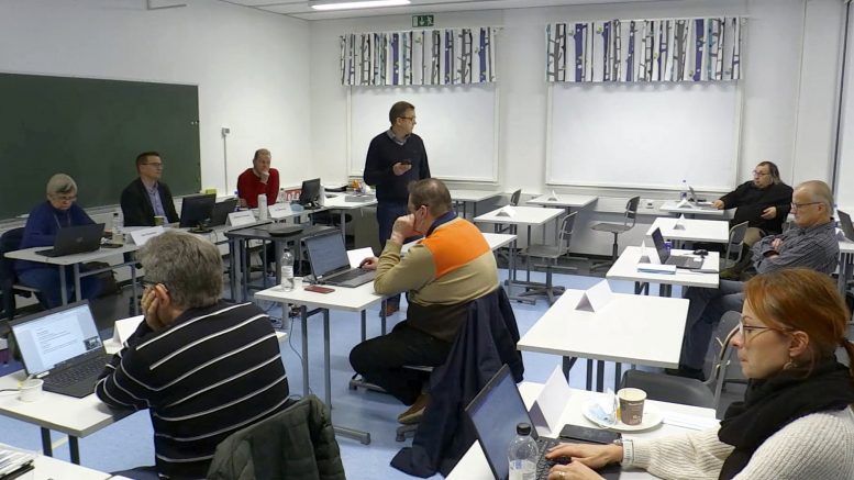 Osa kunnanvaltuutetuista osallistui jo vakiintuneeseen malliin kokoukseen etänä, osa oli paikan päällä. Kuvassa puheenvuoroa käyttämässä Hannu Kaisto. (Kuva nettilähetyksestä)