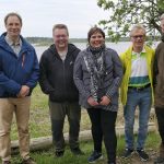 Halosenlahden rannalla Koljun maisemissa Juha Siekkinen (vas.), Heikki Tahkola ja Maarit Satomaa, joille näkymiä esittelivät Tapio Kaarre Halosenlahden kyläyhdistyksestä ja Kari Kaleva Haukiputaan jakokunnasta. Kuva: Tauno Ukkola