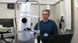 Liikkuvan silmätutkimusyksikön vaunun mahtuu kaikki silmänpohjakuvaukseen tarvittava laitteisto. Kuvassa silmänpohjakameraa esittelee kuvantamisinsinööri Antti Keskitalo.