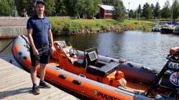 Puusta Oy:n toimitusjohtaja Sauli Laakkonen poseeraamassa uudelleenkastetun meripelastusaluksen vierellä.